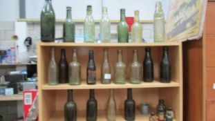 Three shelves of old bottles.