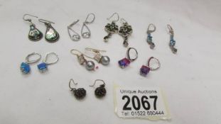 Eight pairs of assorted silver earrings.