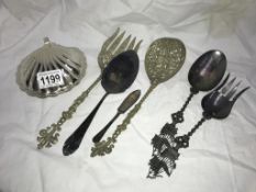 A quantity of various ornate silver plated serving spoons/forks etc.