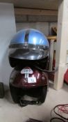 Two classic 'open face' motor cycle helmets.