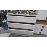 A white three drawer chest.