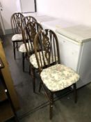 A set of 4 oak wheel back chairs