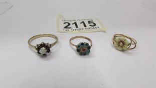 Two 9ct gold floral rings and an unmarked floral ring.