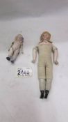 Two small antique porcelain dolls.