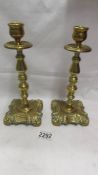 A pair of decorative brass candlesticks.