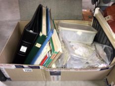 A box of stamp catalogues & bagged loose world stamps (used but envelope paper removed)