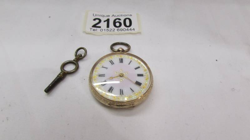 A 14ct gold ladies fob watch with fine chased case, in working order.