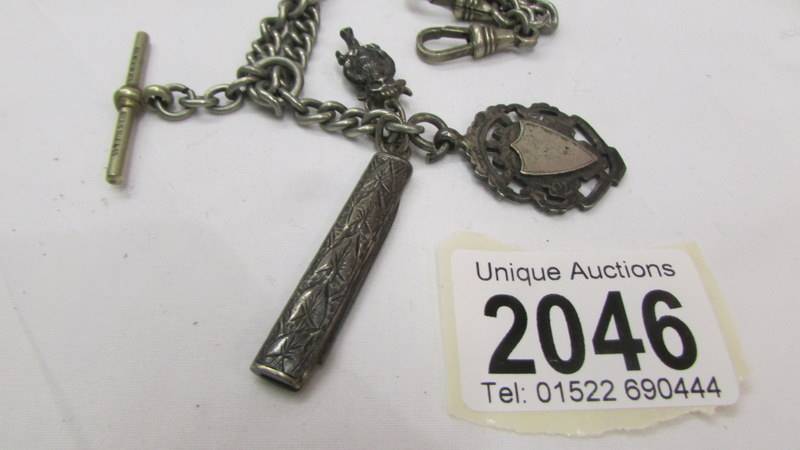 A silver watch fob, a silver pen knife, a white metal imp all on a white metal watch chain. - Image 2 of 2