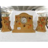 A 1930's ceramic clock garniture.