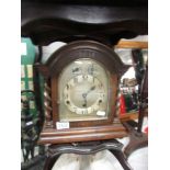 An oak cased bracket clock with barley twist columns, in working order.