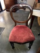 A Victorian mahogany balloon back chair with turned legs