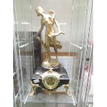 A 19th century French marble and gilt mantel clock surmounted female figure.