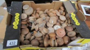 A box of wooden drawer knobs.