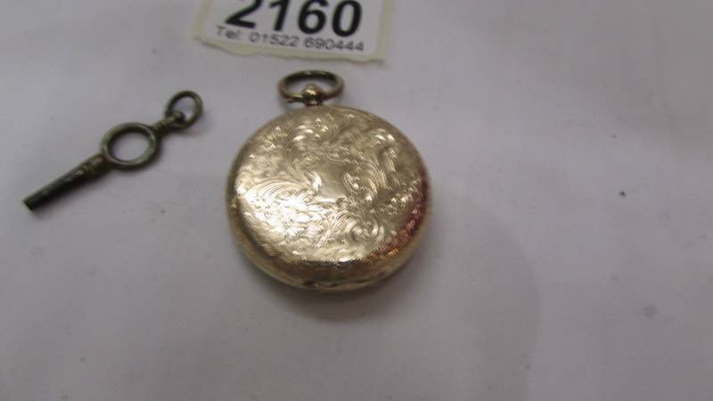 A 14ct gold ladies fob watch with fine chased case, in working order. - Image 2 of 2