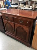 A dark wood stained 2 drawer cupboard with folding top, 96 x 48 x 87 cm high.