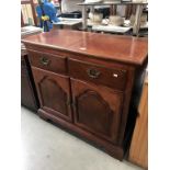 A dark wood stained 2 drawer cupboard with folding top, 96 x 48 x 87 cm high.