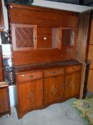 A dark oak display cabinet with carved design. (Collect only).