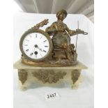A 19th century mantel clock surmounted figure.