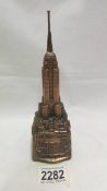 A vintage spelter Empire State Bank money box (missing stopper).