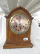 A mahogany inlaid 8 day mantel clock.