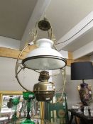 A hanging oil lamp with shade converted to electric.