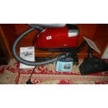 A Miele Compact C2 cat and dog powerline vacuum cleaner with instructions,. in working order.