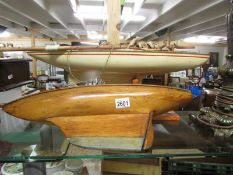 Two old wooden pond yachts, one on stand, need re-rigging.