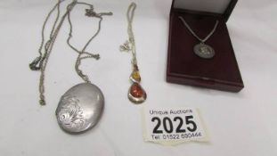 A silver locket, a silver gilt pendant and a silver St Christopher etc.