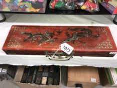 An Oriental lacquered gaming box with dragons on lid ****Condition report****