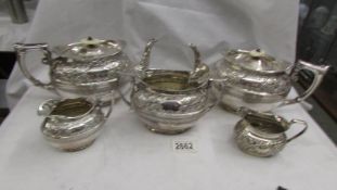 2 silver plate teapots, a sugar bowl and 2 milk jugs.