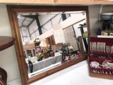 A large dark pine framed bevel edge mirror (73 x 102 cm)