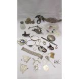 An interesting collection of items including silver nugget, silver pen, brooches, metal items etc.