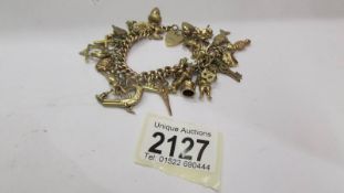 A 9ct gold charm bracelet with 30 charms, 47.2 grams.