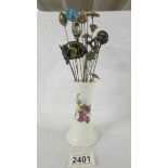 A hat pin stand with 17 hat pins.