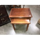 A pair of dark wood stained nest of tables (58cm x 41cm x 49cm high)