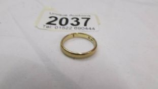 A 9ct gold wedding ring, size J, 2 grams.