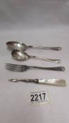 Two silver spoons, a silver fork (80 grams) and a silver manicure item with mother of pearl handle.