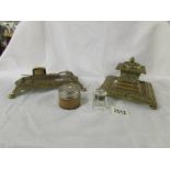 A heavy brass inkwell, a brass stand with candle snuffers and 2 ink wells.