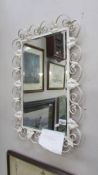 A wrought iron bevel edge mirror 47 x 69 cm