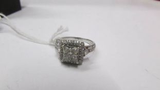 An exquisite diamond cluster ring, marked 14k and 585, size Q. In excellent condition.