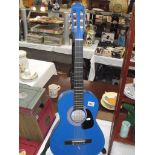 A blue Stretton Payne acoustic guitar,