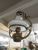 A hanging oil lamp complete with burner and shade.