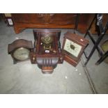 A wall clock and 2 mantel clocks.