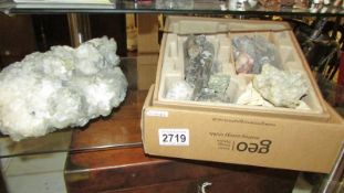 A large rock crystal and a box of other crystals.