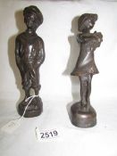 A pair of boy and girl bronze figures, 23 cm tall.