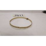 A child's 9ct gold happy elephants bangle.