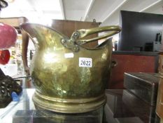 A brass coal scuttle.