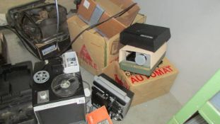 A Canon 8 TV style movie projector, an Automat slide projector and a Tower superb projector.