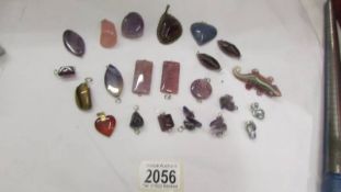 A good collection of agate and other stone pendants and other stones.