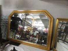 A gilt framed bevel edged over mantel mirror.